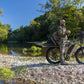 MOVE Electric Scooters - Young Electric E-Explorer Electric Hunting Bike man using his venacular while riding his e-bike in a rocky road near a river